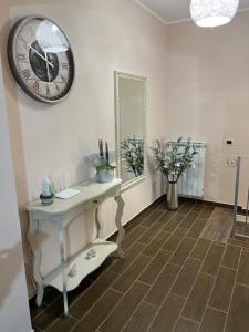 a room with a table and a clock on the wall at B&B MALVETUM in Malvito +114 photos