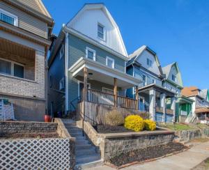a row of houses with stairs in front of them at Beautiful One Bedroom City Oasis in Pittsburgh