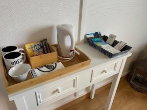a white dresser with a table with a blender on it at Chez Tib in Trégunc
