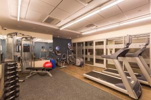 a gym with treadmills and exercise equipment in a room at Edge Hotel Washington Heights in New York