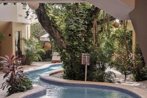 a swimming pool in a building with a resort at Boutique Hotel Posada 06 Tulum in Tulum