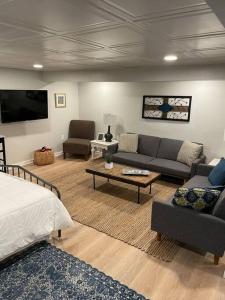 a living room with two couches and a tv at Modern & Chic XL Studio w EZ City Airport Access in Pittsburgh