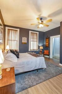 a bedroom with a bed and a ceiling fan at Stylish and Refined with Easy City Access in Pittsburgh