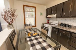 a kitchen with a glass table in a kitchen at Stylish and Refined with Easy City Access in Pittsburgh