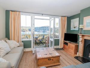 a living room with a couch and a table at 19 Above Town in Dartmouth