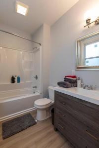 a bathroom with a tub and a toilet and a sink at Urban Oasis Easy City Access Brand New in Pittsburgh