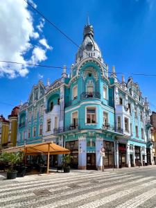 a large blue building on a city street at 26Bricks Luxury Suites in Oradea