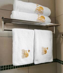 three towels on a towel rack in a bathroom at The hayce residence in Kilifi