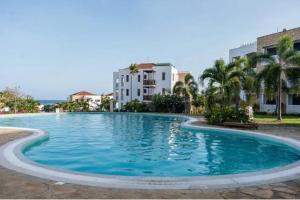 a large swimming pool in front of a building at The hayce residence in Kilifi