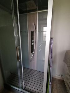 a shower with a glass door in a bathroom at Charmant gîte : Les flambeaux in Mareuil-en-Brie