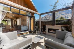 a living room with couches and a fireplace at Little Alp Chalet in Queenstown