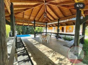 a large wooden pavilion with a table under it at Villa encantadora pino alto J4 in Jarabacoa