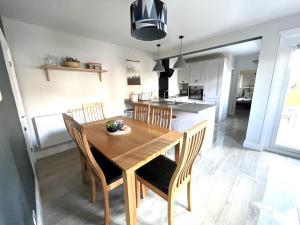 a kitchen and dining room with a wooden table and chairs at Belmont in Southampton