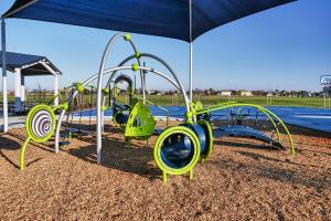 a playground in a park with an umbrella at Bright Sacramento Home about 9 Mi to Dtwn in Sacramento