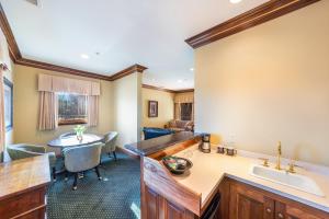 a kitchen and living room with a sink and a table at Stock Farm Inn in Hopland