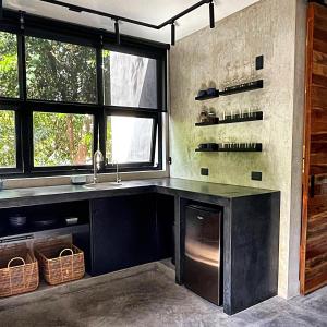 a kitchen with a counter and a sink and windows at LOTE4 - LGBTQ Studios in Playa del Carmen