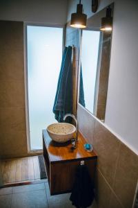 a bathroom with a sink and a mirror at Descanso en La Caleta in Mar de Cobo