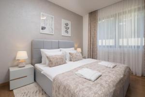 A bed or beds in a room at ENA, Luxury Apartments Opatija