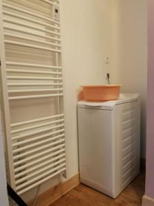 y baño con lavabo encima de una nevera. en Appartement dans une villa au cœur de la ville, en Barcelonnette