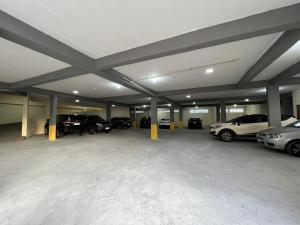 a large garage with cars parked in it at Hotel Garnier in Campos do Jordão