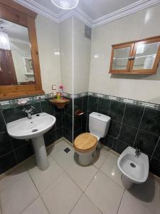 a bathroom with a toilet and a sink at Superbe Appartement centre vue sur mer . in Larache