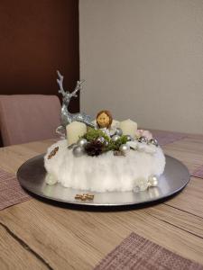 a cake with candles and a doll on top of it at Two cats in Cetingrad