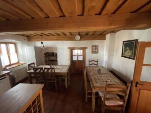 a dining room with wooden tables and chairs at Chalupa U Kocourka in Sedlec