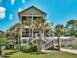 a large house with palm trees in front of it at Southern Grounds in Santa Rosa Beach