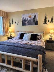a bedroom with a bed with a wooden frame at Mountain View Suite Sleeps 4 Ski OnOff Jiminy Peak in Hancock
