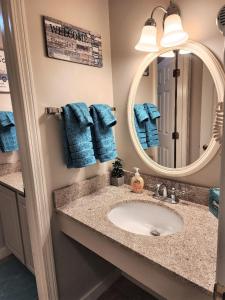 a bathroom with a sink and a mirror and towels at Mountain View Suite Sleeps 4 Ski OnOff Jiminy Peak in Hancock