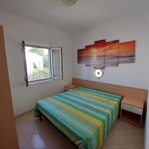 A bed or beds in a room at Villini Giovanna Disanti Még 37 kép