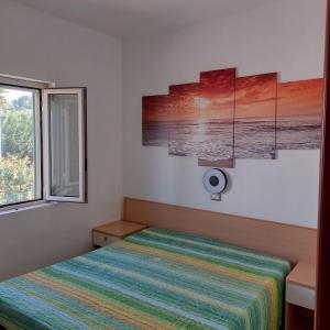 A bed or beds in a room at Villini Giovanna Disanti