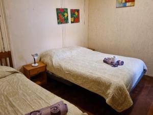 a bedroom with two beds with towels and two candles at Hostal Playa Ancha in Valparaíso