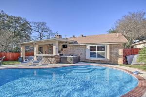 a swimming pool in front of a house at San Antonio Oasis with Hot Tub, Pool and Outdoor Bar! in San Antonio