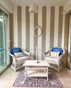 a patio with wicker chairs and a coffee table at Sanremo Collection I in Sanremo
