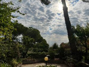 a view of a garden with a cloudy sky at Sanremo Collection I in Sanremo