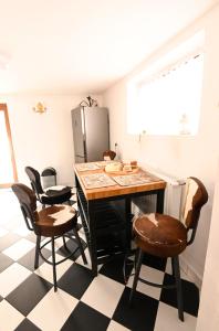 a kitchen with a table with chairs and a refrigerator at Rezydencja Nosal in Zakopane