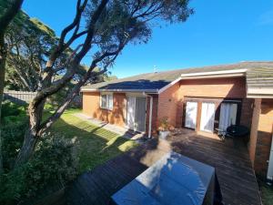 a house with a wooden deck in the yard at Tussock Sands in Point Lonsdale