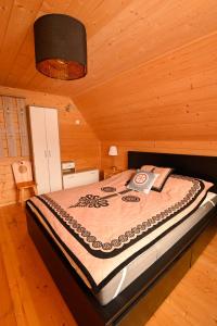 a bedroom with a bed in a wooden cabin at Rezydencja Nosal in Zakopane