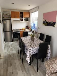 a kitchen with a table and chairs in a kitchen at MANUIA in Coquimbo