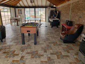 a room with a ping pong table and a couch at MANUIA in Coquimbo