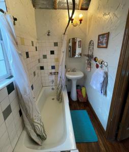 a bathroom with a tub and a sink at The Mexico Cabin at Creekside Camp & Cabins in Marble Falls