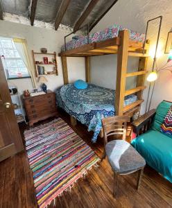 1 dormitorio con litera y silla en The Mexico Cabin at Creekside Camp & Cabins, en Marble Falls