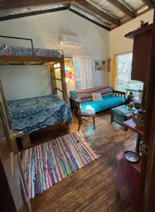 a bedroom with two bunk beds and a couch at The Mexico Cabin at Creekside Camp & Cabins in Marble Falls