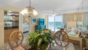a dining room and living room with a table and chairs at Beachcrest 903 in Santa Rosa Beach