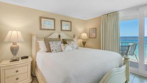 a bedroom with a bed with a view of the ocean at Beachcrest 903 in Santa Rosa Beach +52 photos