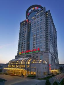a large hotel building with a large building at Celebrity International Grand Hotel in Beijing