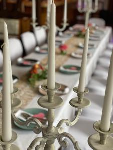 a long table with white candles on it at Gasthaus Neue Mühle in Westhausen