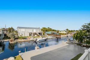 a view of a marina with a boat in the water at Big Pine Key Dreams in Big Pine Key