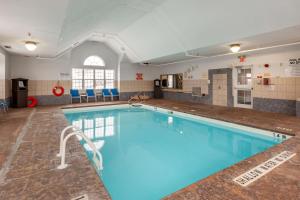 a large swimming pool with blue water at Best Western Plus Woodstock Inn & Suites in Woodstock
